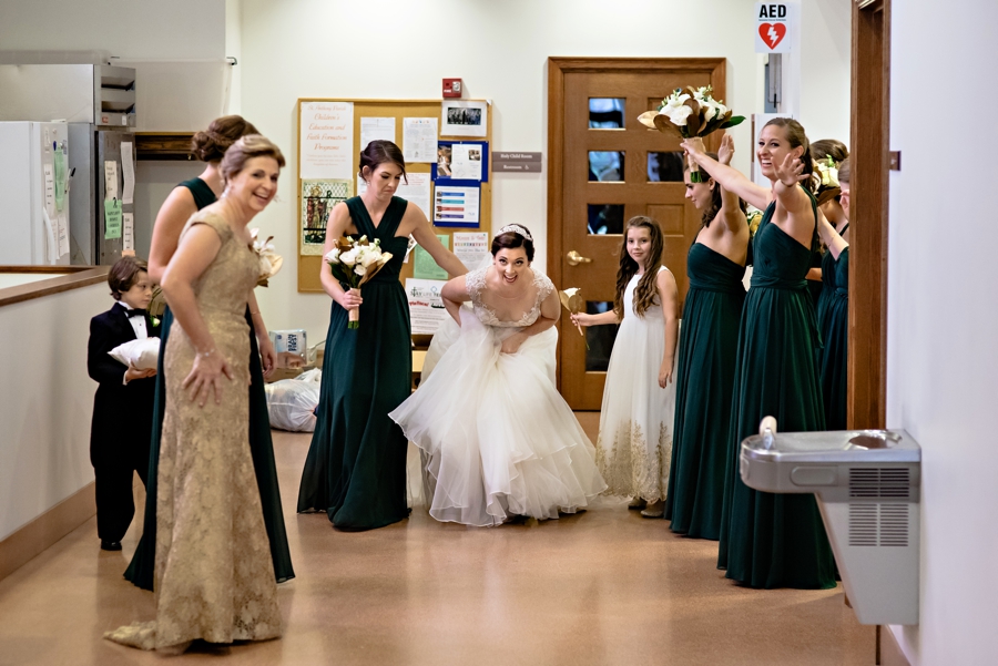 Bridesmaids hide the Bride as she enters the church.